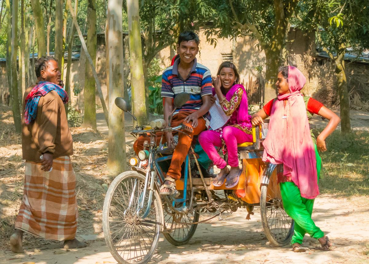 young bangladeshian people sitting, two of them sitting on a bicycle taxi. Pic Martti Laukkanen, FLOM